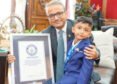 Four-year-old New Jersey author Advay Jain holds his book Dino Learns Not To Waste Food after setting a Guinness World Record.
