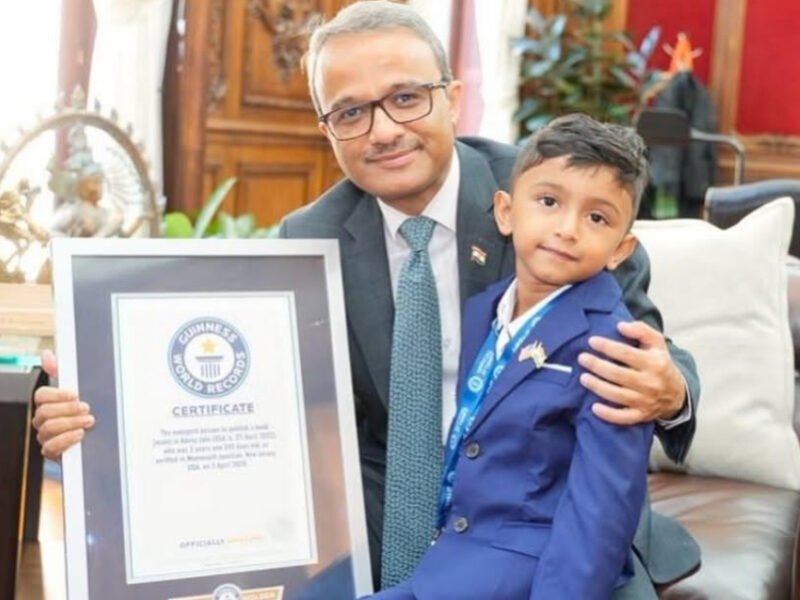 Four-year-old New Jersey author Advay Jain holds his book Dino Learns Not To Waste Food after setting a Guinness World Record.