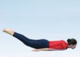 Person practicing Shalabhasana with legs raised, knees straight and arms beside the body