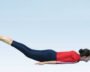 Person practicing Shalabhasana with legs raised, knees straight and arms beside the body