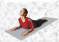 Person practicing Bhujangasana with chest lifted and palms beside the chest