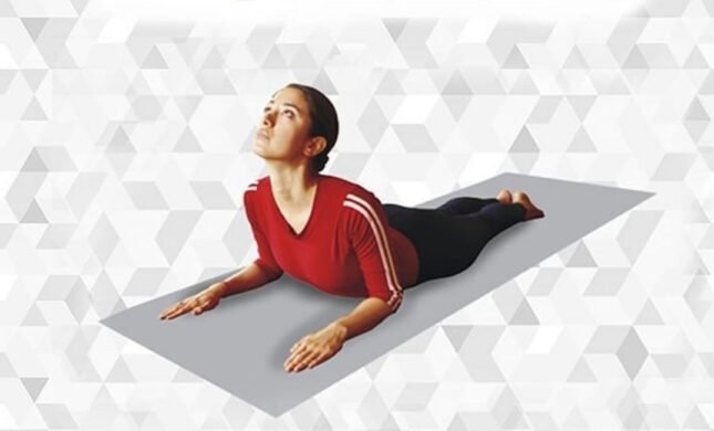 Person practicing Bhujangasana with chest lifted and palms beside the chest