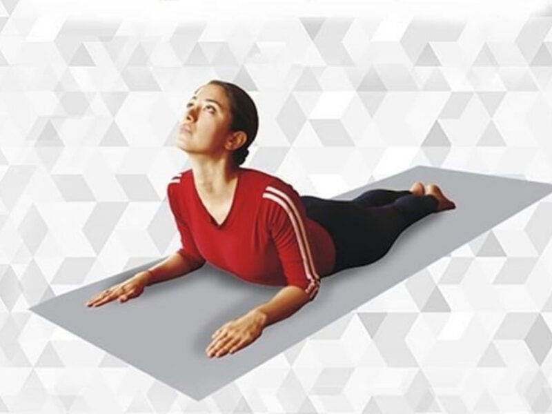 Person practicing Bhujangasana with chest lifted and palms beside the chest