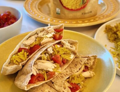 Mediterranean pita pockets filled with chicken, yellow rice, tzatziki and cherry tomatoes