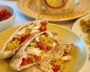 Mediterranean pita pockets filled with chicken, yellow rice, tzatziki and cherry tomatoes