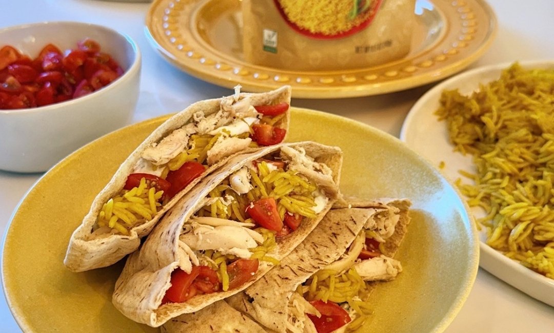 Mediterranean pita pockets filled with chicken, yellow rice, tzatziki and cherry tomatoes