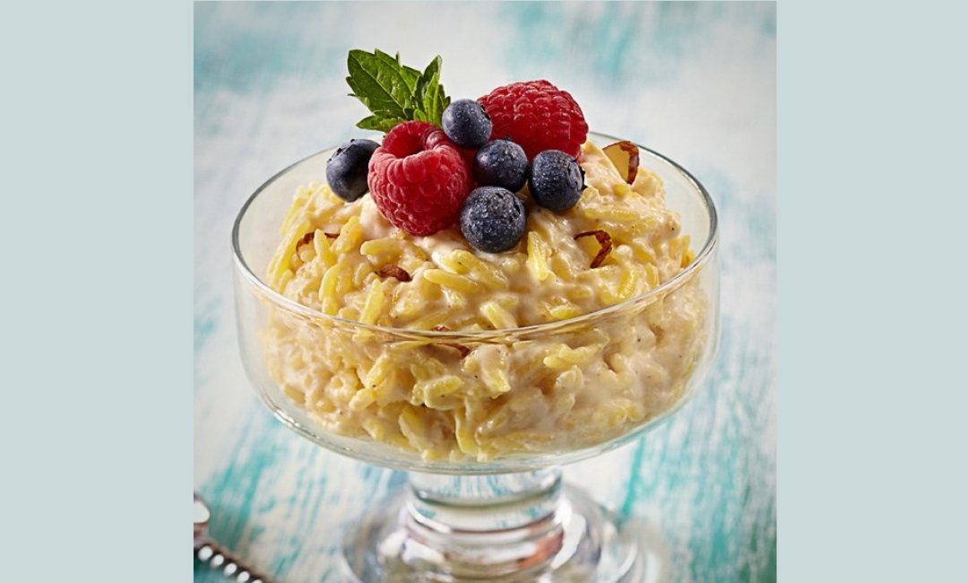 Indian rice pudding topped with shaved dark chocolate, berries and slivered almonds