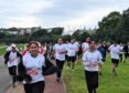Participants take part in the Viksit Bharat Unity Run with yoga and meditation near Washington, organized by the Embassy of India.